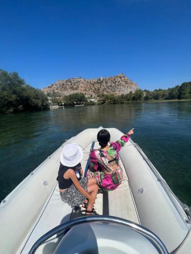 two people on a boat on a river at Villa Teverde in Shkodër