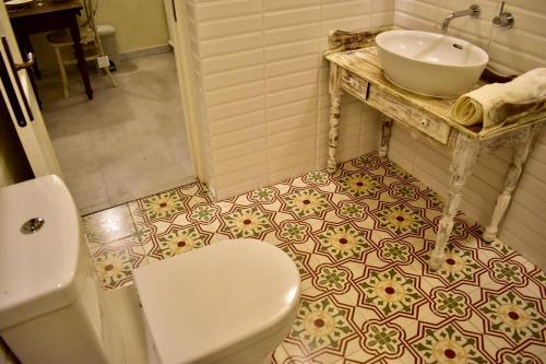 a bathroom with a white toilet and a sink at Arcanum apartment 1 very close to seafront bus station and ferry to Valletta in Senglea