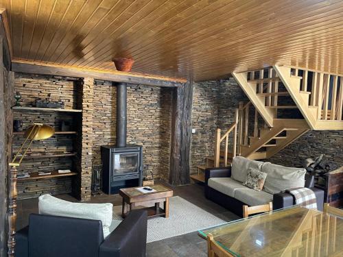 a living room with a couch and a fireplace at Casa de Xisto Santo António in Videmonte