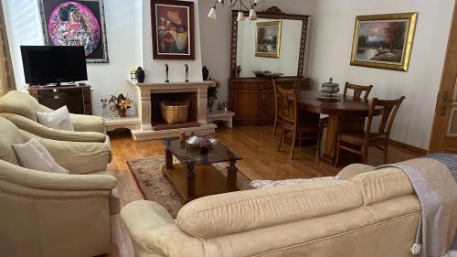 a living room with two couches and a table at Appartement tout confort Valpaços 2 in Valpaços