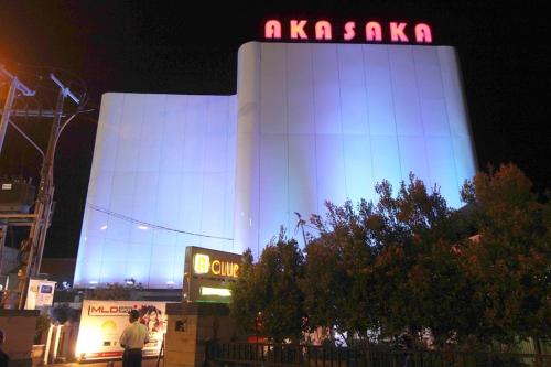 a large building with a sign on it at night at Choice Stay Hotel Denpasar in Denpasar