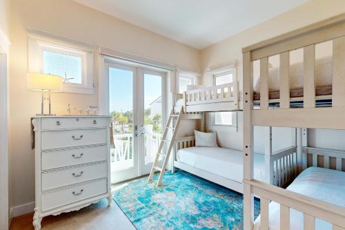 a bedroom with a bunk bed and a desk at Deja Vu at Carillon in Carillon Beach