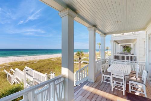 a porch with a table and chairs and the beach at Deja Vu at Carillon in Carillon Beach