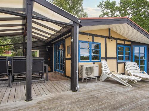 a large deck with chairs and a house at 6 person holiday home in Børkop-By Traum in Børkop