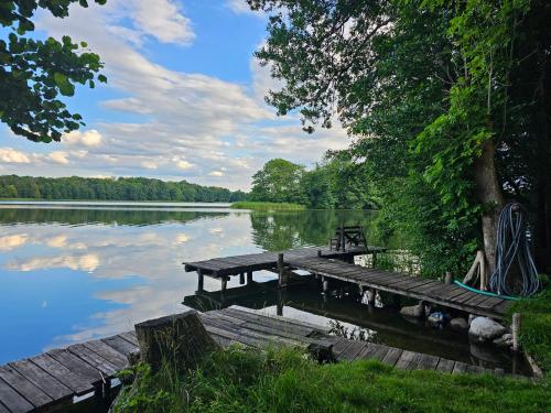 a picnic table on a dock on a lake at Haus Seeblick in Stary Gieląd