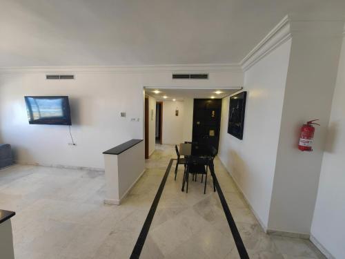 a room with white walls and a table and chairs at City Bleu Maroc in Tangier