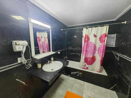 a bathroom with a sink and a mirror at City Bleu Maroc in Tangier