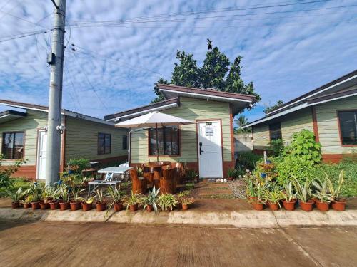 a house with a porch with plants in front of it at Homey Inn-Olango Island Staycation ,block 1 lot 15 in Lapu Lapu City
