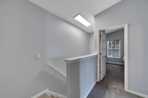 a hallway with white walls and a skylight at Spacious 3BR Family Home Near Sponge Docks in Tarpon Springs