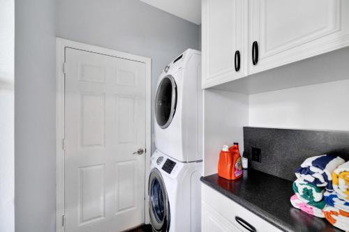 a kitchen with a white refrigerator and a washing machine at Spacious 3BR Family Home Near Sponge Docks in Tarpon Springs