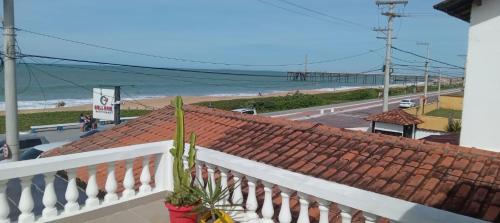 a balcony with a view of the beach at Atlântico Hotel in Rio das Ostras