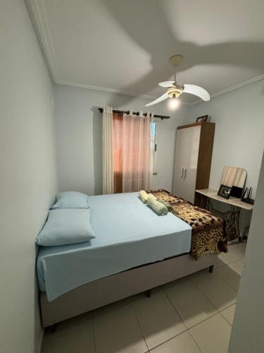 a bedroom with a bed and a ceiling fan at Bela Providência in Aracaju