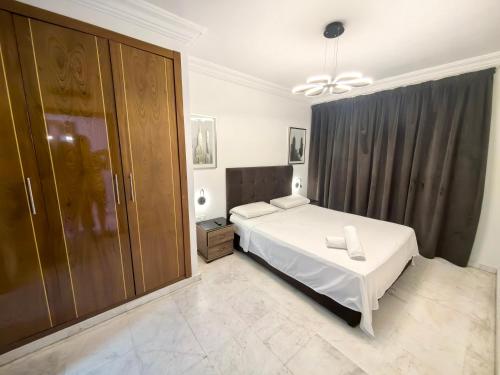 a bedroom with a bed and a large closet at City Bleu Maroc in Tangier