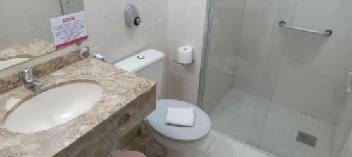 a bathroom with a sink and a toilet and a shower at Atlântico Hotel in Rio das Ostras