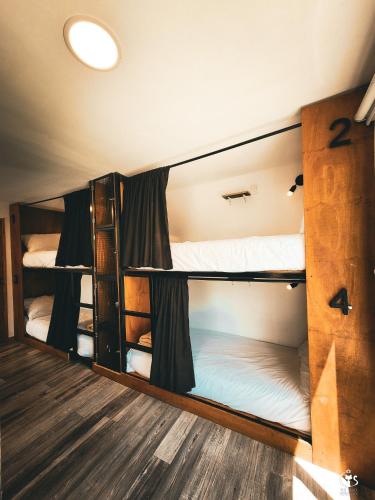a room with three bunk beds in it at Dormís Acá in Esquel