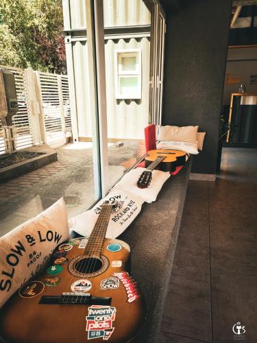 a guitar sitting on a counter next to a window at Dormís Acá in Esquel