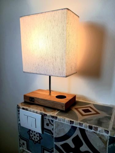 a lamp sitting on top of a table at Masseria Petra in Martano