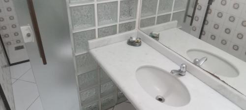 a bathroom with a white sink and a shower at Atlântico Hotel in Rio das Ostras