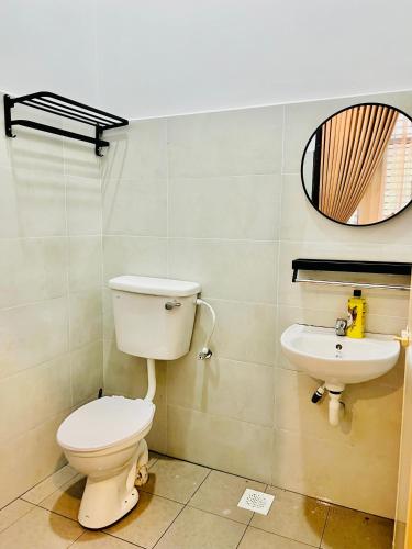 a bathroom with a toilet and a sink at AM Homestay Kijal in Kemaman