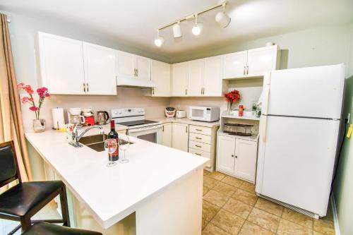 a kitchen with white cabinets and a white refrigerator at Lake Simcoe 4 Bedroom Family Home Ideal Toronto Area Retreat in Innisfil