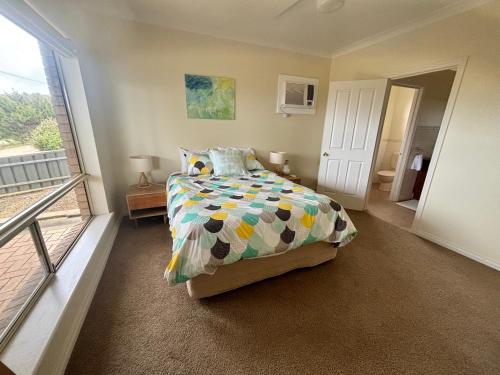 a bedroom with a bed and a balcony at Sea Valley Views in Port Lincoln