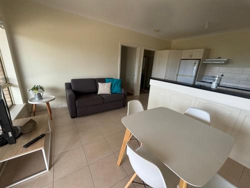 a living room with a table and a couch at Sea Valley Views in Port Lincoln