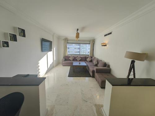 a living room with a couch and a table at City Bleu Maroc in Tangier