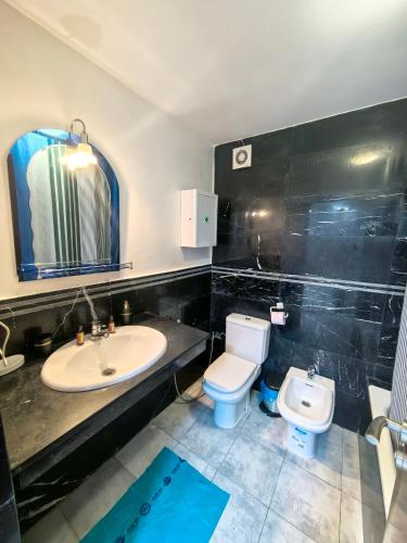 a bathroom with a sink and a toilet at City Bleu Maroc in Tangier