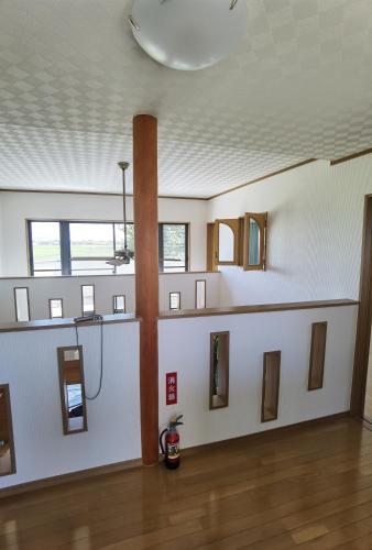 a room with a white wall with a row of windows at リニューアル 高島市風車村琵琶湖畔別荘サウナ付きファミリーグループ大歓迎テラス炭火BBQ Reiwa House in Takashima
