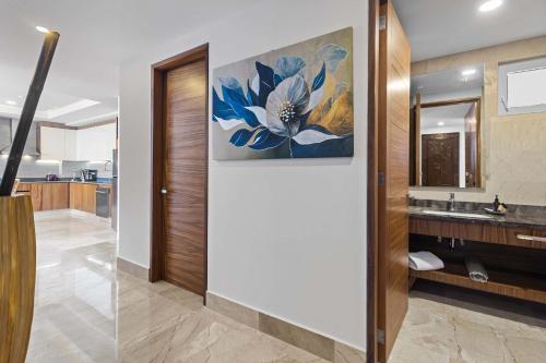 a bathroom with a sink and a painting on the wall at Blue Horizon Luxury Condo in Puerto Vallarta