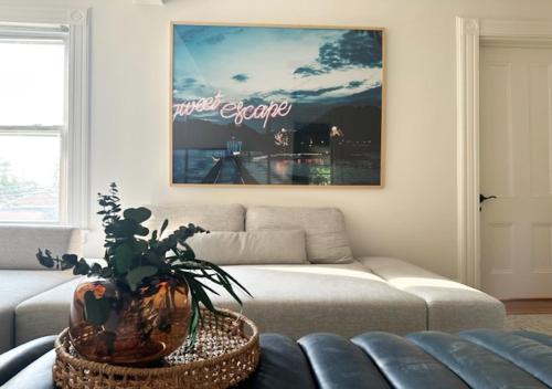 a living room with a couch and a picture at Sweet Escape, 2BR apt in BEACH community, Only 1 hr to NYC! in Norwalk