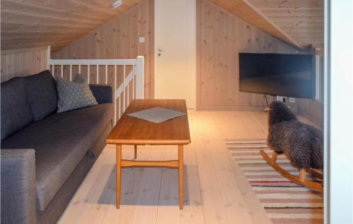 a dog standing in a living room with a couch and a table at Lovely Home In Treungen in Fjone