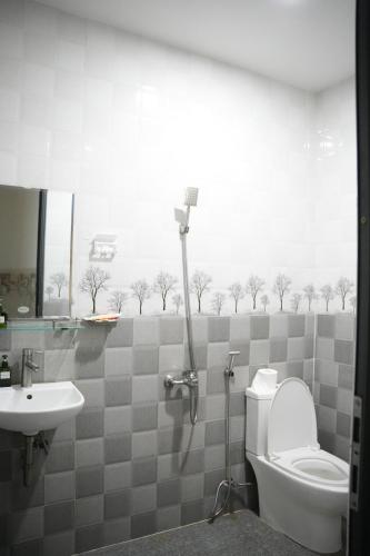 a bathroom with a toilet and a sink at Naomi House Phan Thiet in Phan Thiet