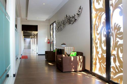 a living room with a couch and a hallway at Choice Stay Hotel Denpasar in Denpasar