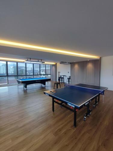 a large room with two ping pong tables in it at Kuching Near GalaCity Armadale Residence Apartment in Kampong Tabuan