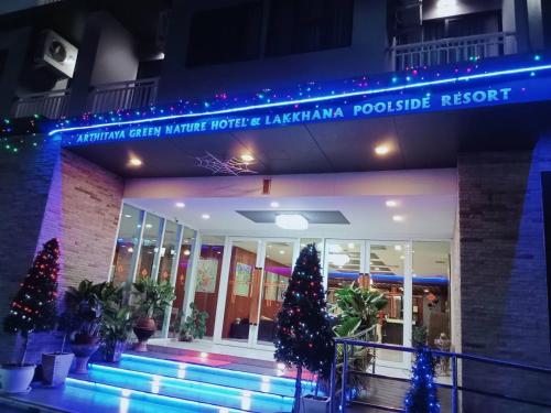 a building with christmas trees in front of it at Arthitaya Green Nature Hotel & Lakkhana Poolside Resort in Pattaya North