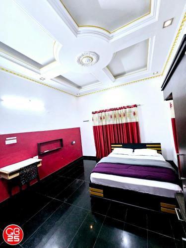 a bedroom with a bed and a desk in it at GB25 inn in Trivandrum