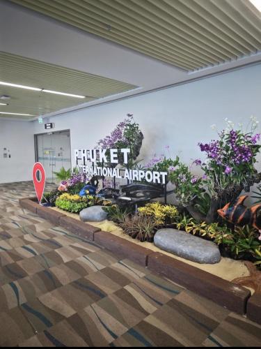 a sign for a flower show in a building at Haru Inn Airport in Ban Bo Han