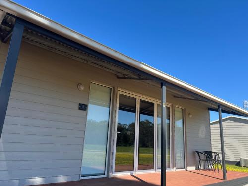 a screened porch with glass doors on a house at Country Living in Dubbo