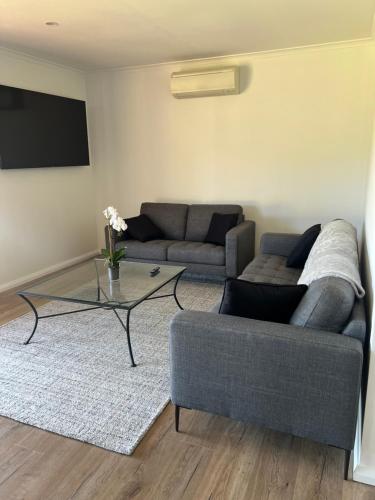 a living room with a couch and a coffee table at Country Living in Dubbo