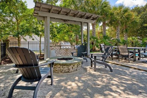 a group of chairs sitting around a fire pit at Tolater in DeBordieu Colony home by Peace Vacations in Georgetown