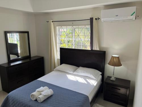 a bedroom with a bed with two towels on it at Mandeville luxury in Mandeville