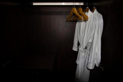 a group of white clothes hanging on a rack at Vrest Hotel in Phnom Penh