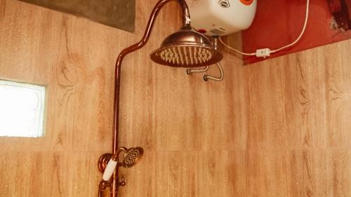 a lamp hanging on a wall in a room at Cokro Hinggil - Traditional View in Sleman