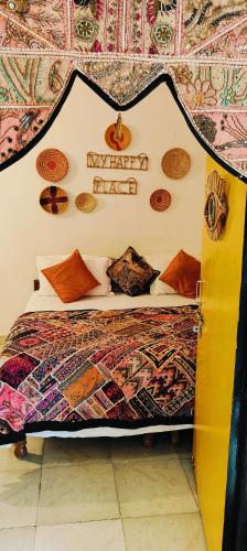 a bedroom with a bed with a sign on the wall at Blue Eye Hostel in Jaisalmer