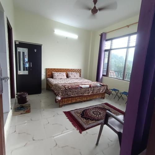 a bedroom with a bed and a large window at Swaran bnb near Mcleodganj in Dharamshala