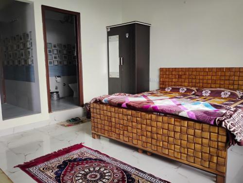 a bedroom with a bed and a mirror and a rug at Swaran bnb near Mcleodganj in Dharamshala