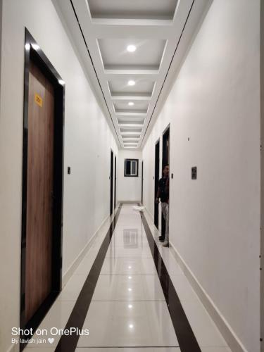 a man standing in the hallway of a building at Hotel Modi Palace, Chanderi MP in Chanderi