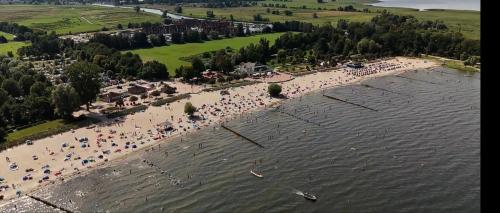 an aerial view of a beach with a crowd of people at Ferienhaus Urlaubstraum in Ueckermünde