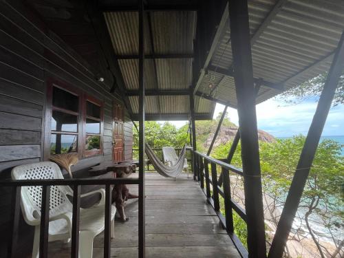 a porch of a house with a hammock at Tao Thong Villa 1 in Koh Tao